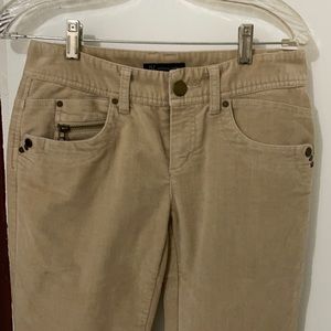 Inc tan, zipper on pockets and lower side pants zipper.
